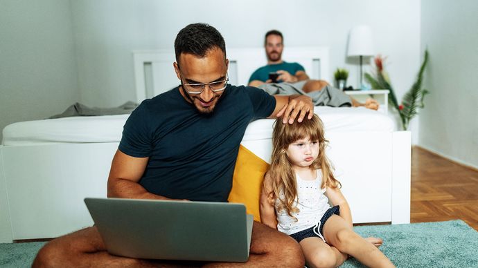 Father and daughter using laptop